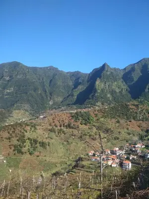 a village on a hill with mountains in the background at Matilde House in São Vicente