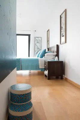 a bedroom with a bed and a stool in a room at Luxury Ocean Front Villla in Calheta