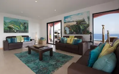 a living room with two couches and a table at Luxury Ocean Front Villla in Calheta