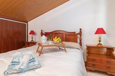 a bedroom with a bed with a table on it at Apartment lucy in Arco da Calheta