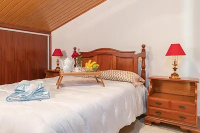 a bedroom with a bed with a table on it at Apartment lucy in Arco da Calheta