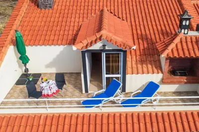two chairs and a table on a roof at Apartment lucy in Arco da Calheta