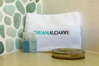 a towel and two bottles of cleaner on a table at LuzBay Pool Apartments in Luz