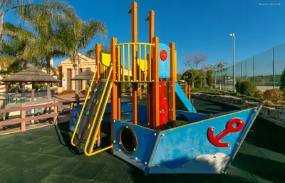 a playground with a slide in a park at LuzBay Pool Apartments in Luz