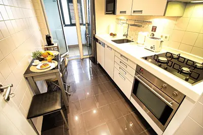 a small kitchen with a table and a stove at Formosa Infinity Pool Apartment in Funchal