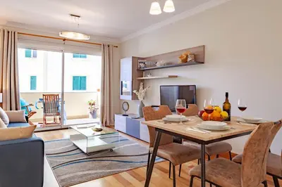 a living room with a table with chairs and a couch at Apartment Formosa - Infinity pool in Funchal