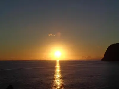 a sunset over the ocean with the sun in the sky at Apartment Formosa - Infinity pool in Funchal
