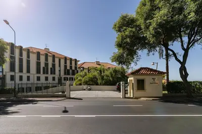 an empty parking lot with a building and a tree at Apartment Formosa - Infinity pool in Funchal