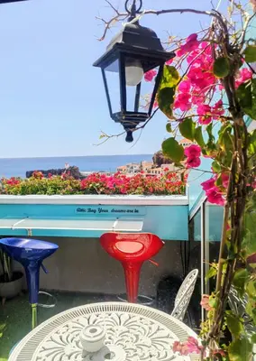 a white bedroom with two beds and a doorway at ATTIC BAY in Câmara de Lobos