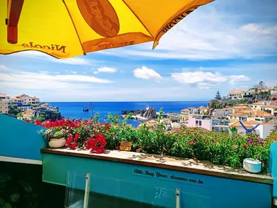 a living room with a couch and a table at ATTIC BAY in Câmara de Lobos