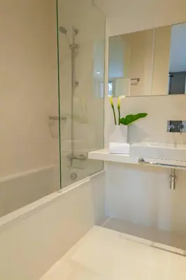 a bathroom with a glass shower and a sink at Solar do Ribeiro in Funchal