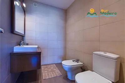 a bathroom with a toilet and a sink at OurMadeira - Casa da Belita in Calheta