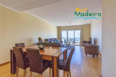 a dining room and living room with a table and chairs at OurMadeira - Casa da Belita in Calheta