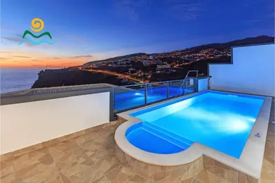 a swimming pool on the roof of a house at OurMadeira - Casa da Belita in Calheta