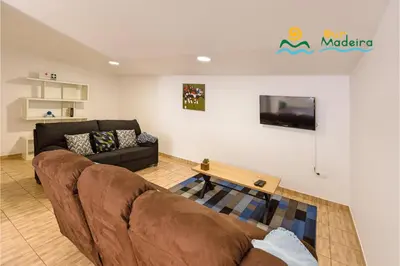a living room with a couch and a table at OurMadeira - Casa da Belita in Calheta