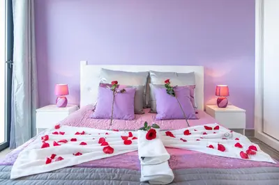 a bedroom with a bed with red roses on it at Casa das Abertas in Calheta