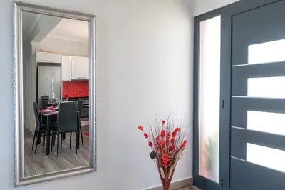a mirror in a dining room with a table and a kitchen at Casa das Abertas in Calheta