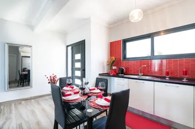 a kitchen and dining room with a table and chairs at Casa das Abertas in Calheta