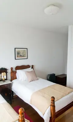 a living room with a red couch and chairs at Casa da Manta in Fajã da Ovelha