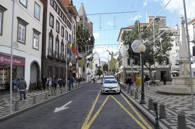 a car driving down a street in a city at Apartamentos Funchal by Petit Hotels in Funchal