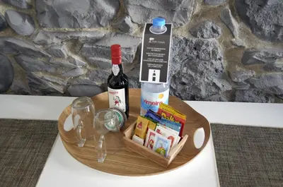 a wooden plate with a bottle of wine and glasses at Apartamentos Funchal by Petit Hotels in Funchal