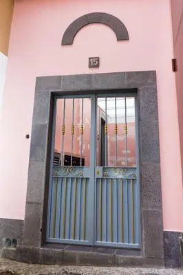 a door on a building with a sign on it at Apartamentos Funchal by Petit Hotels in Funchal