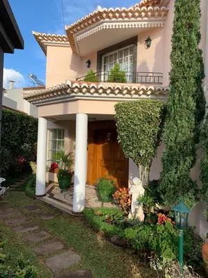 a house with a porch and plants on it at Vila Tagus Garajau in Caniço