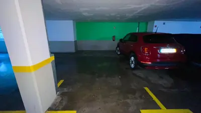 a red car parked in a parking garage at Apto Barreiro by Susy's Holidays in Funchal