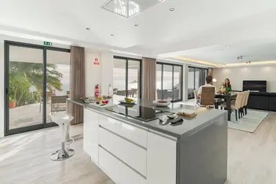 a kitchen and living room with a view of the ocean at Sky Villa by An Island Apart in Funchal