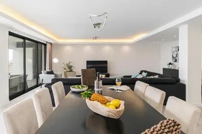 a dining room with a table with a bowl of fruit on it at Sky Villa by An Island Apart in Funchal