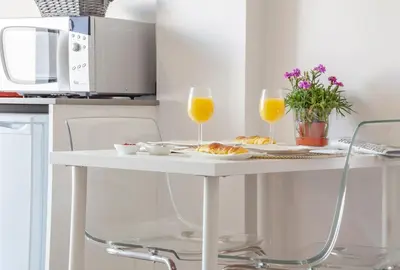 a white table with two glasses of orange juice at Infinito Azul in Caniço