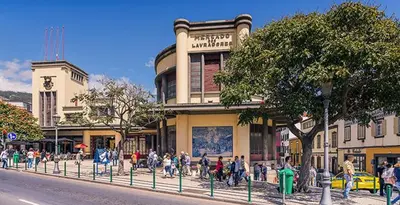 a group of people walking in front of a building at Funchal Village Studios in Funchal
