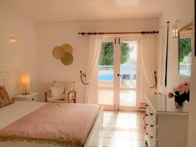 a bedroom with a bed and a sliding glass door at Villa Luz Bay w Private Pool in Luz