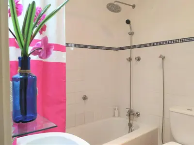 a bathroom with a blue vase with flowers in it at Villa Luz Bay w Private Pool in Luz