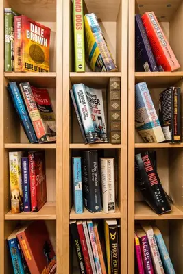 a book shelf filled with lots of books at Villa Luz Bay w Private Pool in Luz