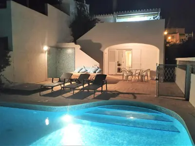 a swimming pool in front of a house at night at Villa Luz Bay w Private Pool in Luz