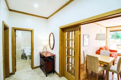 a living room with a table and a dining room at Quinta Miramar in Funchal