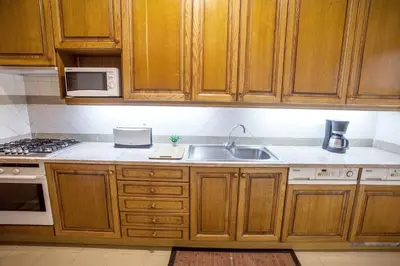 a kitchen with wooden cabinets and a sink at Quinta Miramar in Funchal