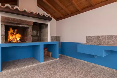 a fireplace in a living room with a blue mantle at CAPTAIN´S HOUSE in Paul do Mar