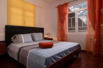 a bedroom with a bed with an orange pillow on it at CAPTAIN´S HOUSE in Paul do Mar