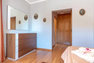 a bedroom with a dresser and a mirror on the wall at Apartment Laranjeiras in Calheta