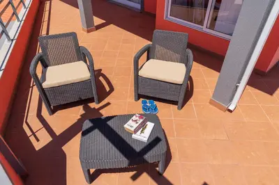 an overhead view of two chairs and a table on a balcony at Apartment Laranjeiras in Calheta