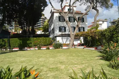 a large yard in front of a white building at Quinta Da Penha De Franca in Funchal