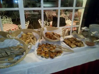 a table with various types of bread and pastries on it at Quinta Da Penha De Franca in Funchal