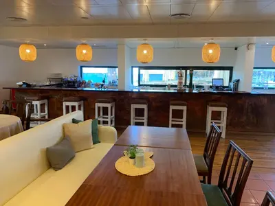 a living room with a couch and a table and a bar at Quinta Da Penha De Franca in Funchal
