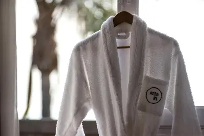 a white robe is hanging on a window at ARTS IN Hotel Conde Carvalhal in Funchal
