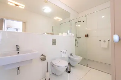a bathroom with a toilet and a sink and a shower at ARTS IN Hotel Conde Carvalhal in Funchal