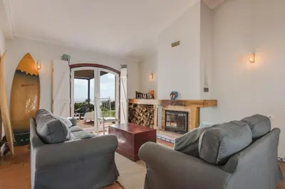 a bedroom with a white bed with a window at Casa das Furnas - Eco Home in Vila do Bispo