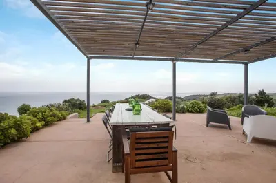 a house with a surfboard in the yard at Casa das Furnas - Eco Home in Vila do Bispo