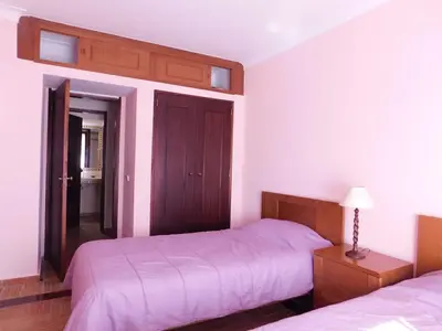 a bedroom with a bed and a night stand with a lamp at Vista da Atlantica in Luz
